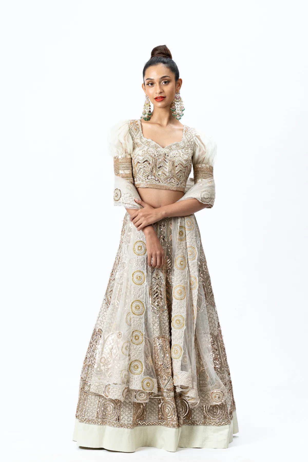 Beige Hand-embroidered Lehenga paired with Puff-sleeved Hand-embroidered Blouse and Hand-embroidered Dupatta with buttis