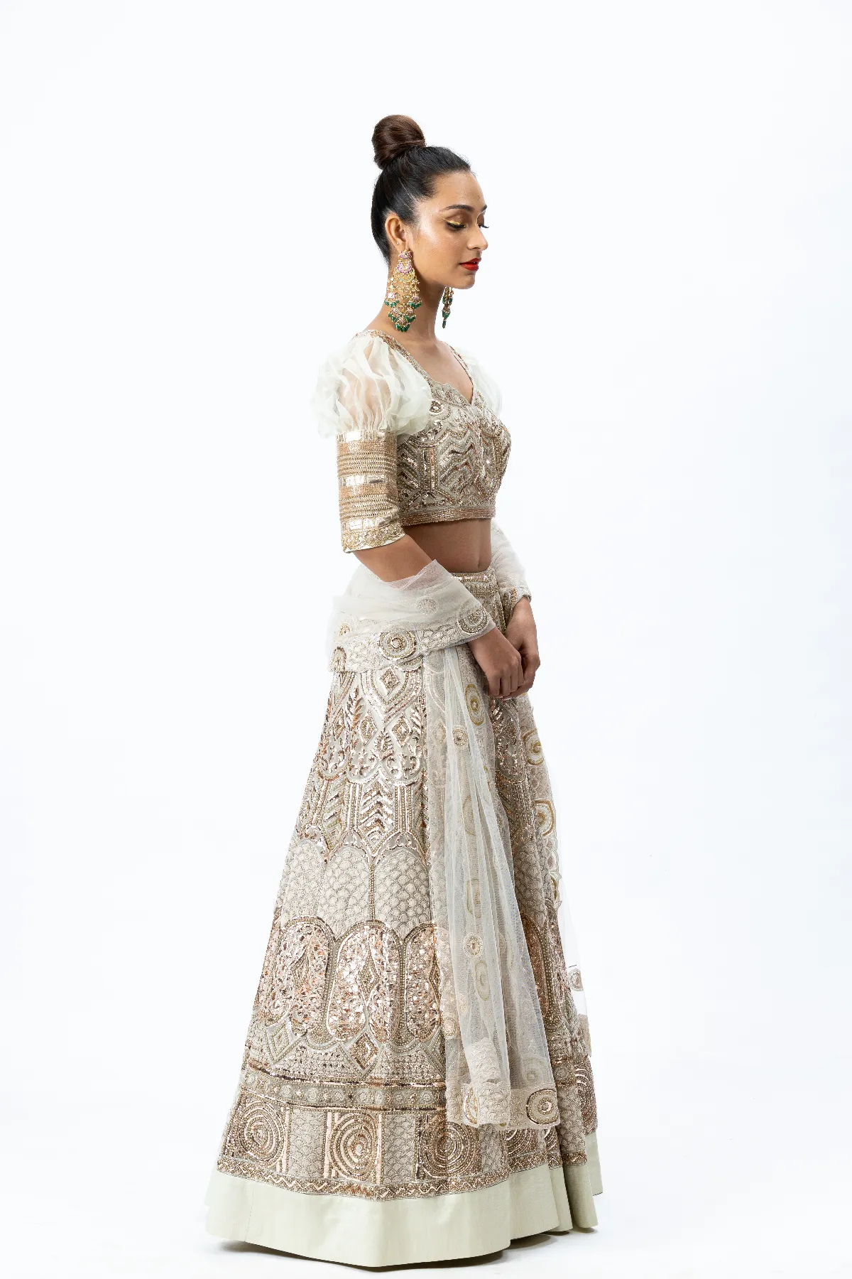 Beige Hand-embroidered Lehenga paired with Puff-sleeved Hand-embroidered Blouse and Hand-embroidered Dupatta with buttis